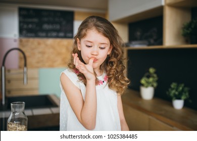 Little Girl Licking Fingers After Lunch 