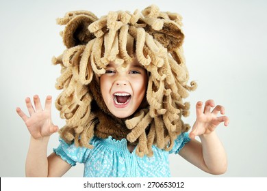 Little girl with lion mane costume roaring