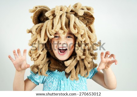 Little girl with lion mane costume roaring