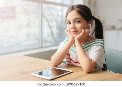 Little Girl Listening To Audiobook At Home