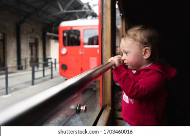 Little Girl Look Out Of Windows In A Swiss Train