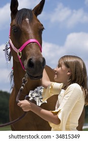 A little girl looking with joy and affection at a beautiful horse that has been given to  her as a gift on her birthday.