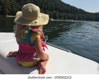 Little girl looking out over the water from a boat on Lake Cumberland in Kentucky