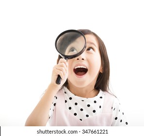 little girl looking through a magnifying glass