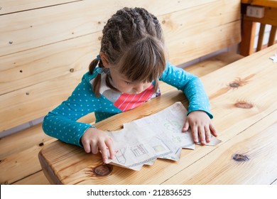 Little Girl Looking At The Treasure Map.