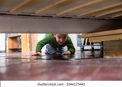 Little Girl Looks Under The Bed