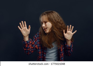 Little Girl Makes Face Leaning Against The Glass