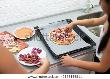 little girl makes pizza at home