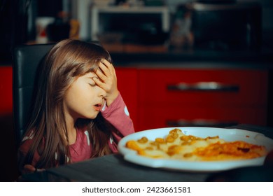 
					Little Girl Making a Face palm Gesture at the Dinner Table. Fussy picky eater feeling disappointed in her homemade meal
					