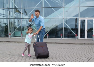 Little Girl And Man Says Goodbye At The Airport. They Wave Their Hand.