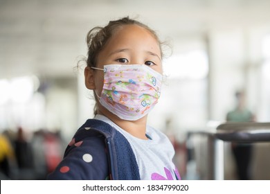 Little Girl In Mask Sitting In The Airport And Airplane While Covid Epidemia