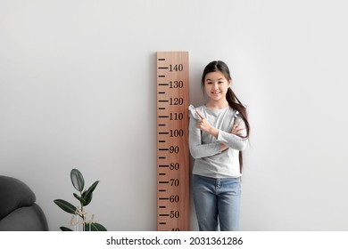 Little Girl Measuring Height At Home