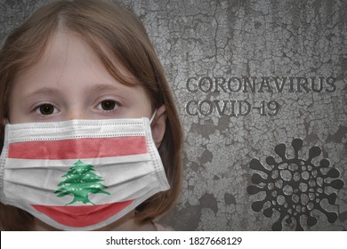 Little Girl In Medical Mask With Flag Of Lebanon Stands Near The Old Vintage Wall With Text Coronavirus, Covid, And Virus Picture. Stop Virus