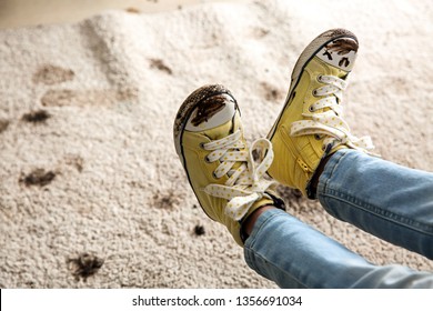 Little Girl In Muddy Shoes Messing Up Carpet At Home