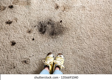 Little Girl In Muddy Shoes Messing Up Carpet At Home