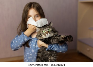 Little Girl With A Napkin And A Cat In The Foreground At Home. Concept Of Allergies To Cats