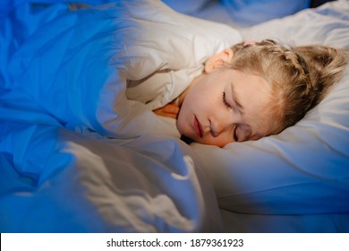 A Little Girl Naps In Bed In Her Room, Sees A Nightmare In Sleep. Restless, Unhealthy Sleep In Children After Watching A Horror Movie, Computer Game.