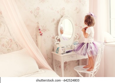 Little Girl Near The Mirror.  A Little Fashionista In The Bedroom.