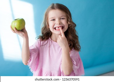 Little Girl With No Teeth Eats Fruit Apple