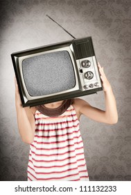 little girl with old retro television on her head