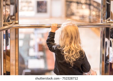 Little Girl On Glass Elevator