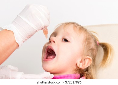 The Little Girl On Reception At The Doctor Receives The Polio Vaccine, A Child Being Treated For Influenza, The Child Takes The Medicine In The Hospital