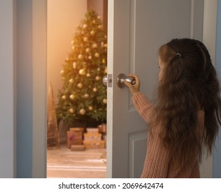 Little girl opening door to room decorated for Christmas - Powered by Shutterstock