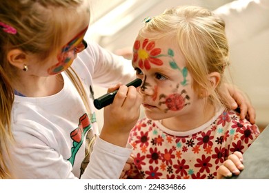 Little girl and painting face as butterfly