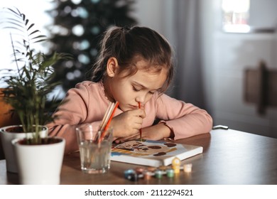 
Little girl is painting with gouache. Happy little girl painting in at home. The girl draws a picture by numbers. - Powered by Shutterstock