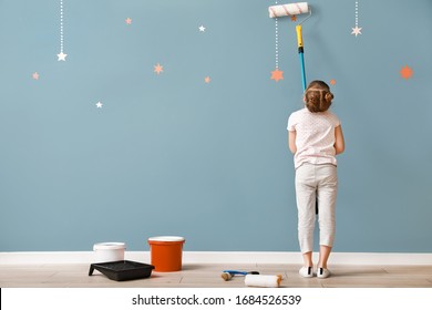 Little Girl Painting Wall In Room