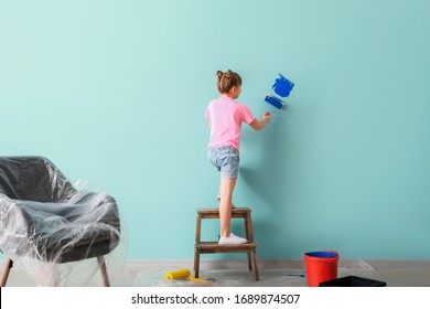 Little Girl Painting Wall In Room