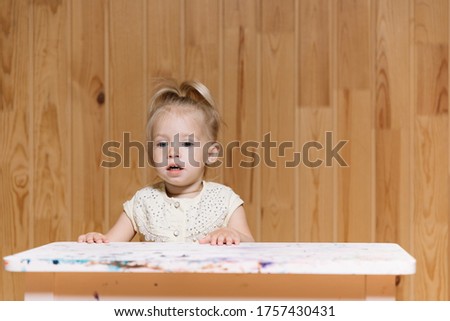 Similar – Baby girl playing with hair clips sitting in the floor