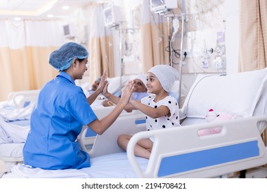 Little girl patient playing with nurse sitting on bed at hospital - Shutterstock ID 2194708421