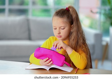 Little Girl With Pencil Case At Home