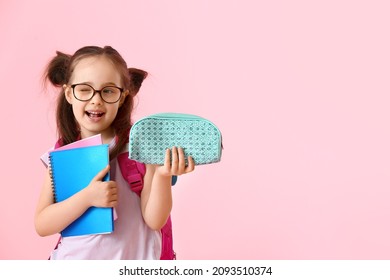 Little Girl With Pencil Case And Notebooks On Color Background