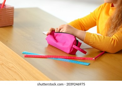 Little Girl With Pencil Case At Table, Closeup