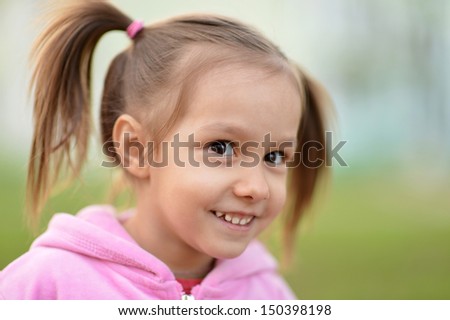 little girl in pink on a walk in the park
