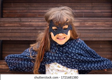 Little Girl Play In Costume Mask Of Scary Superhero. Childhood