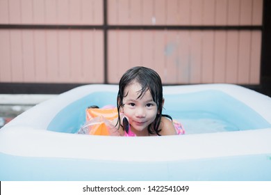 Little Girl Play In The Kiddie Pool.