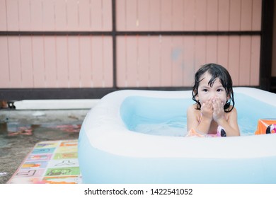 Little Girl Play In The Kiddie Pool.