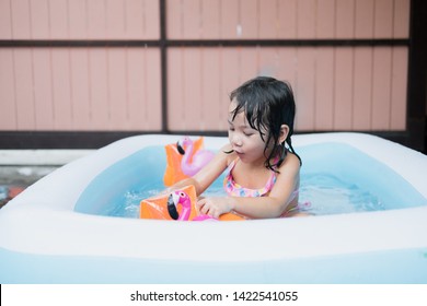 Little Girl Play In The Kiddie Pool.