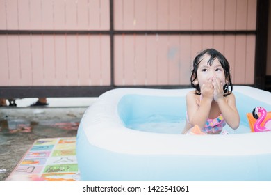 Little Girl Play In The Kiddie Pool.