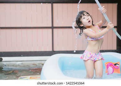 Little Girl Play In The Kiddie Pool.