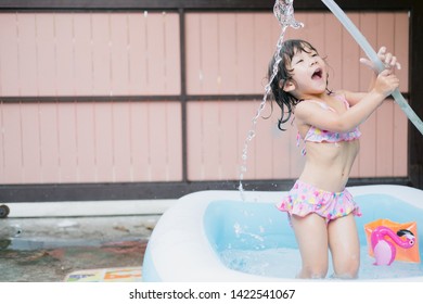 Little Girl Play In The Kiddie Pool.