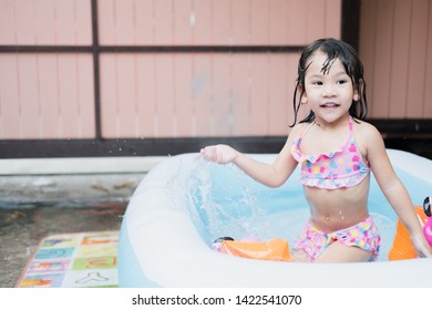 Little Girl Play In The Kiddie Pool.