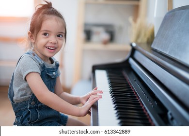 Little Girl Play Piano And Sing A Song In Living Room, Music, Kid, Baby, Child Concept