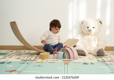 Little Girl Playing With A Balance Board Toy At Home. Montessori Playroom. 