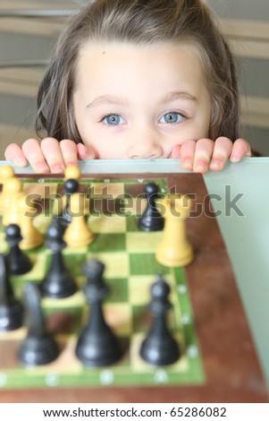 Similar – lifestyle shot of smart kid girl playing checkers at home