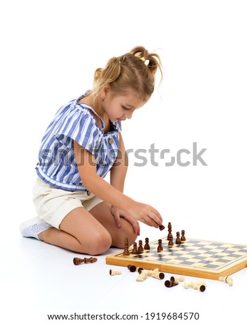 Similar – lifestyle shot of smart kid girl playing checkers at home