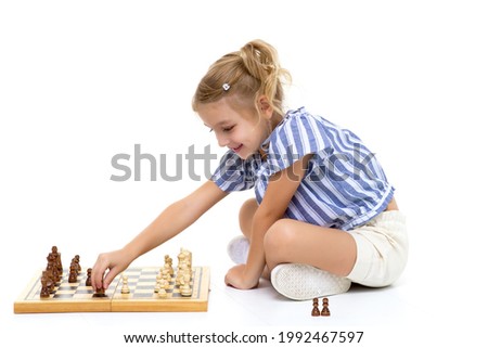 Similar – lifestyle shot of smart kid girl playing checkers at home